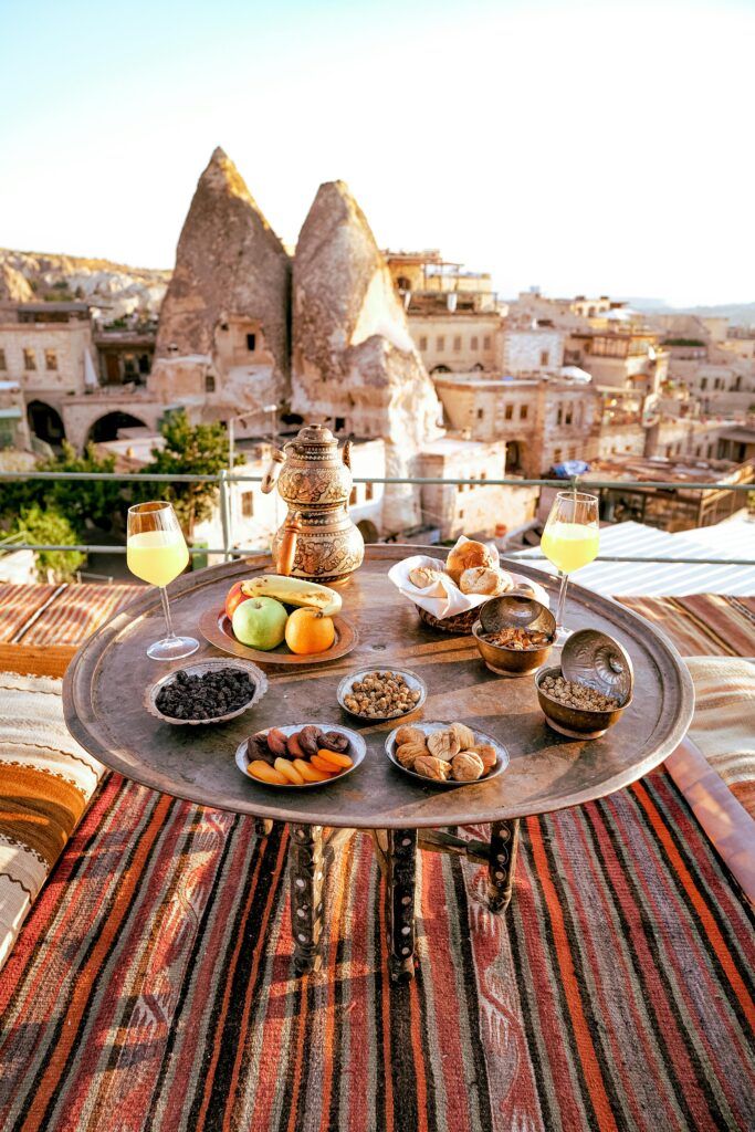 Traditional Turkish breakfast set against the backdrop of Cappadocia's unique landscape.